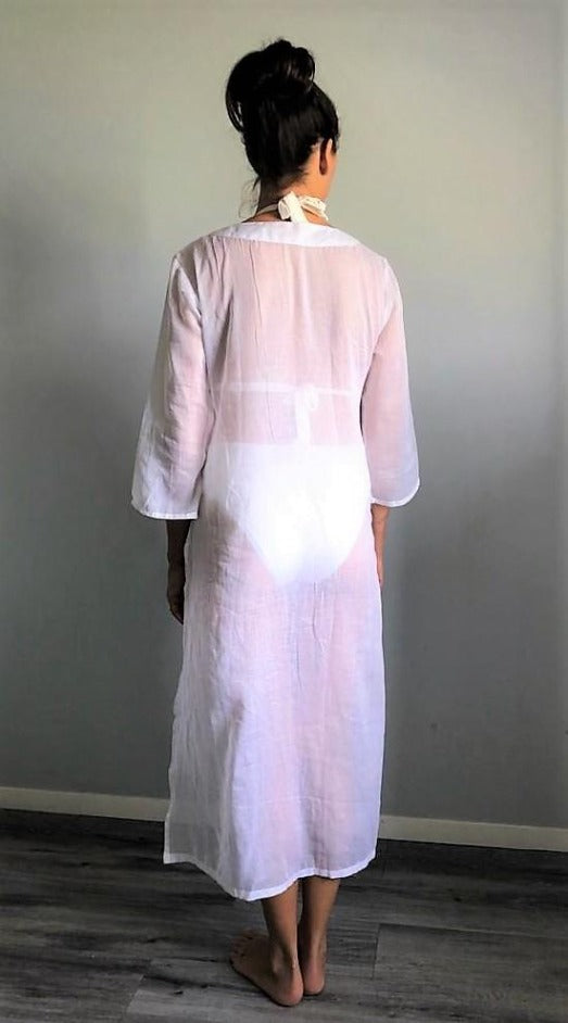 A woven cotton voile tunic dress in white. Available in aqua, coral and white.