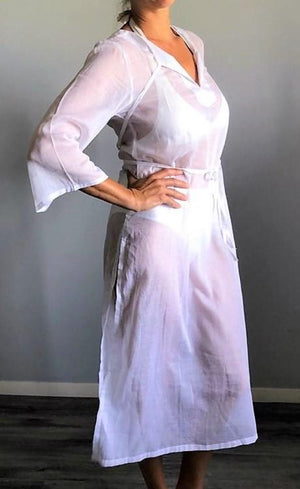 A woven cotton voile tunic dress in white. Available in aqua, coral and white.